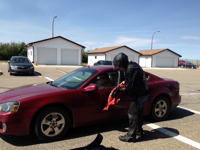 Paul making friends and getting his shirt signed by some lady waiting to cross the boarder
